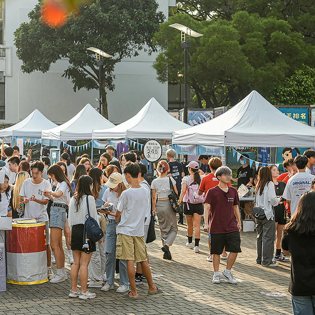 White pop-up canopy tents at an outdoor market