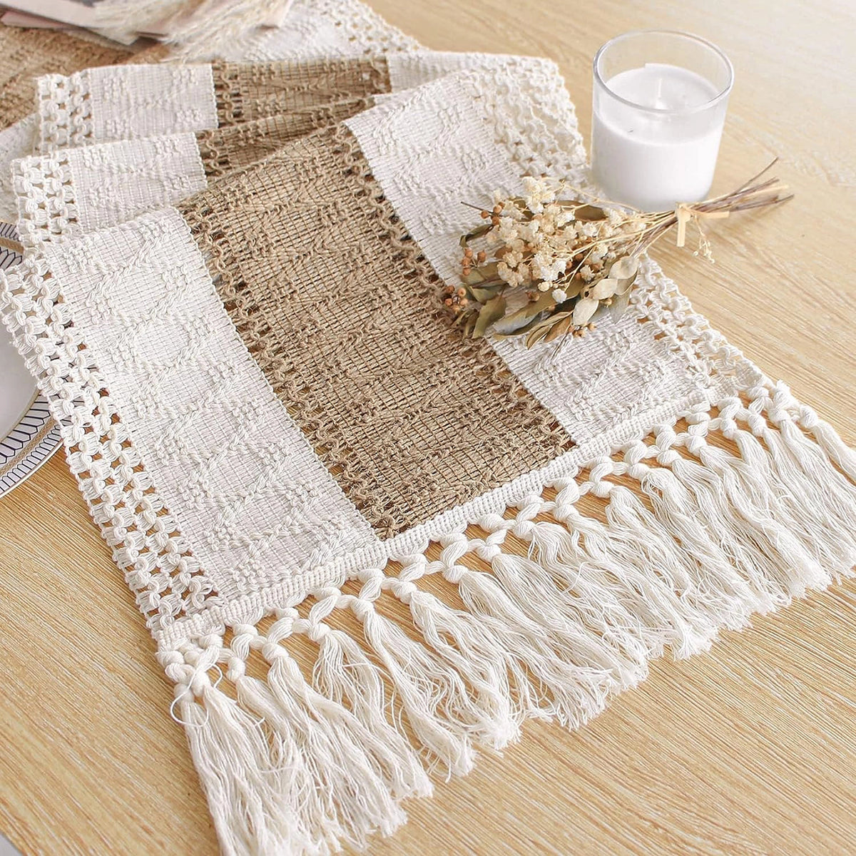Boho woven table runner with coffee stripe and tassel fringe on a wood table
