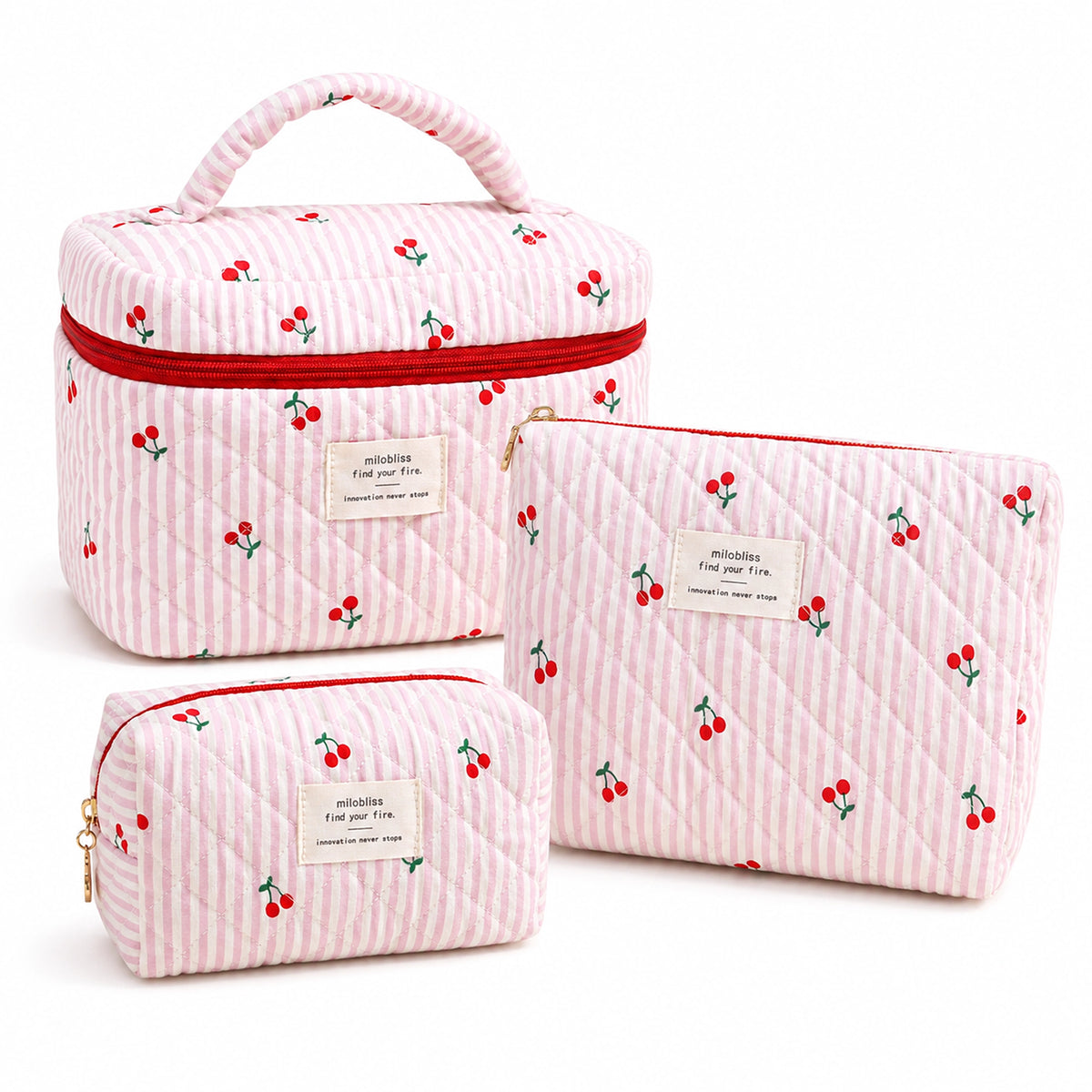 Three quilted fabric cosmetic bags in a matching cherry print, including a large rectangular case with a top handle and two smaller zip pouches, shown on a white background.