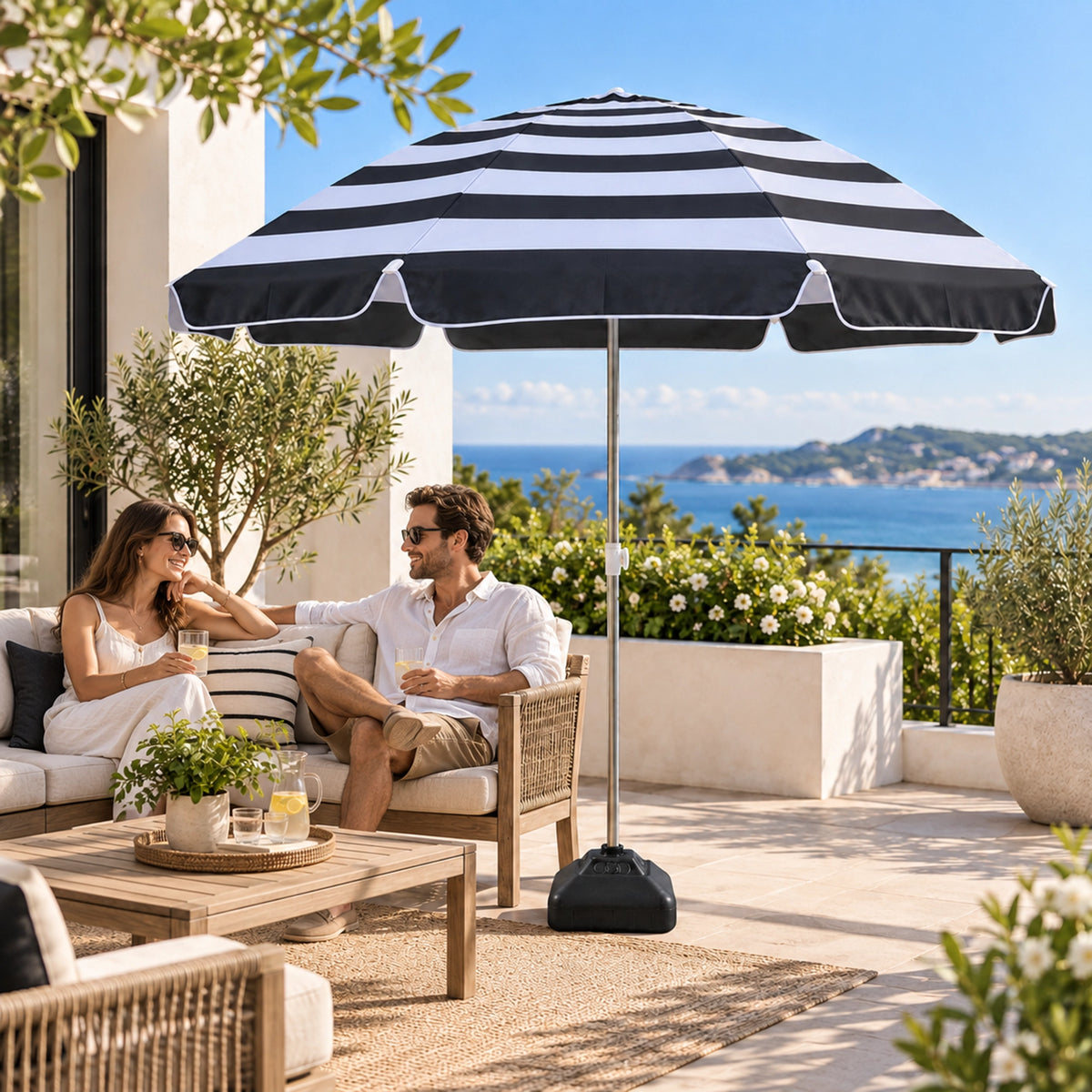 Black and white striped patio umbrella on a seaside terrace