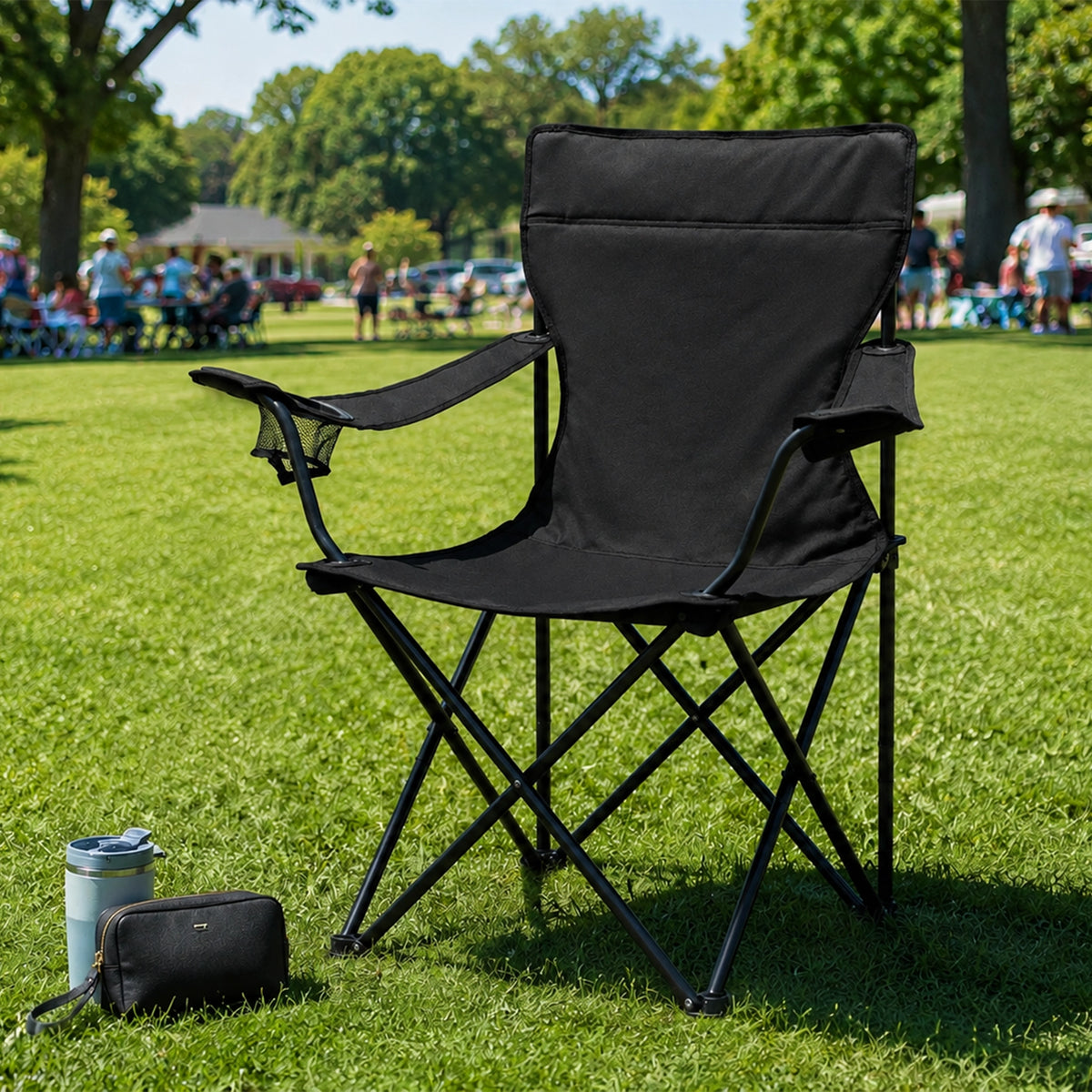 Black folding camping chairs viewed from behind at the beach