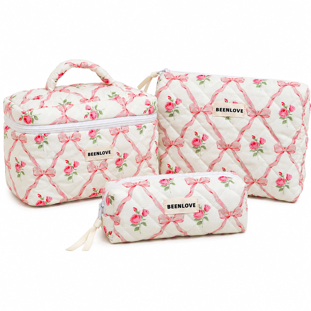 Three quilted cosmetic bags in a matching set with a pink and green floral bow pattern, displayed on a clean white background.